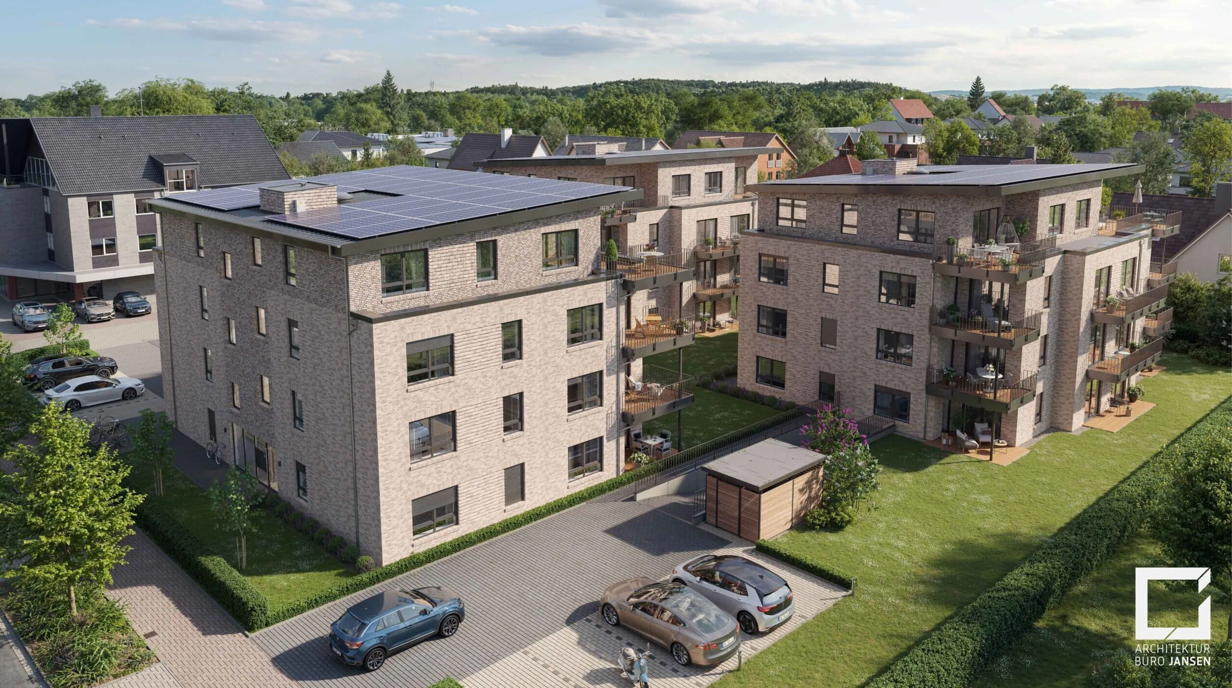 Luftaufnahme moderner Wohngebäude mit Sonnenkollektoren, umgeben von grünen Rasenflächen und geparkten Autos, unter einem klaren Himmel.